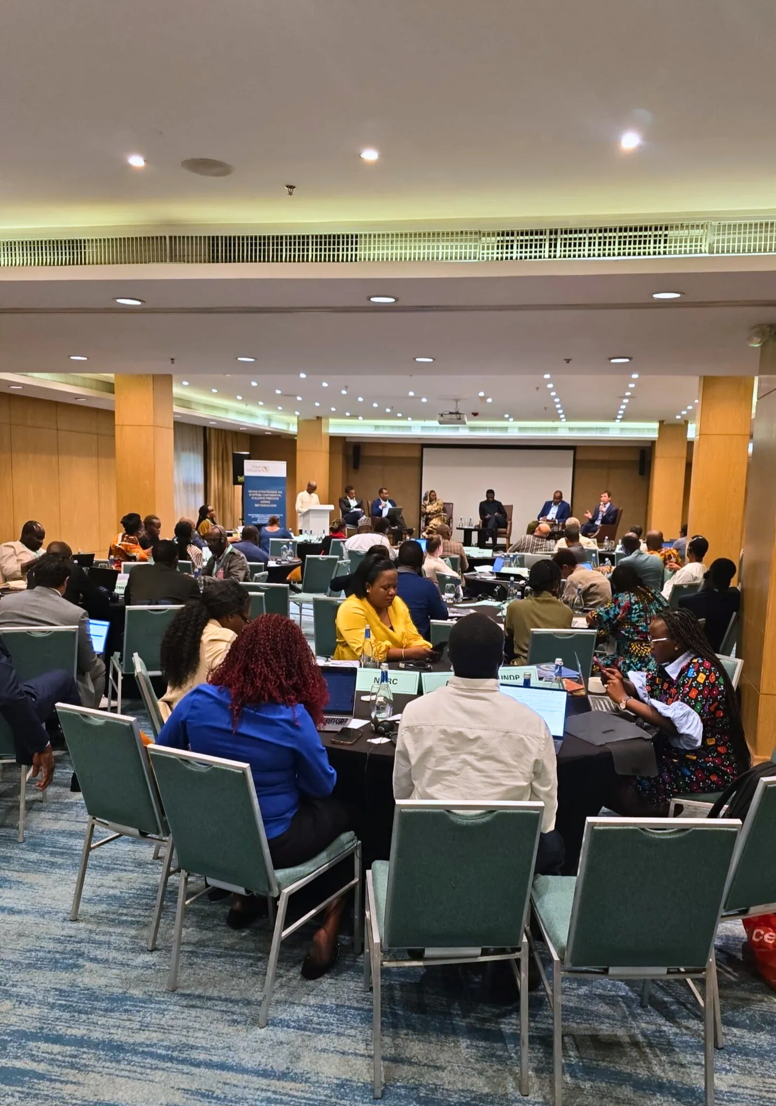 Conference attendees in session